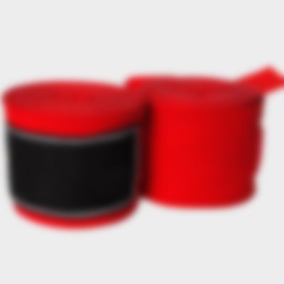 Red and black hand wraps used for wrist and knuckle support in boxing.